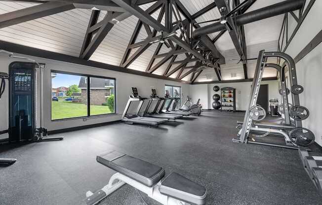 A spacious home gym with a variety of equipment.