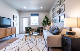 a living room with a couch and a tv at Sonder Fields in Happy Valley, OR