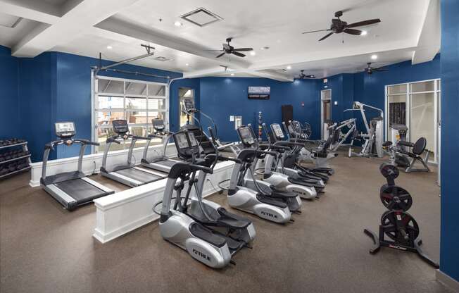 a gym with treadmills and other exercise equipment