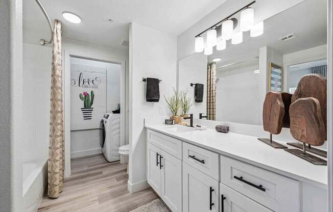 A bathroom with a white vanity and a shower area. at Lazo Apartment Homes, Chandler, AZ 85225