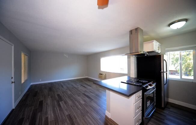 Atrium Court kitchen area with appliances and unfurnished living room