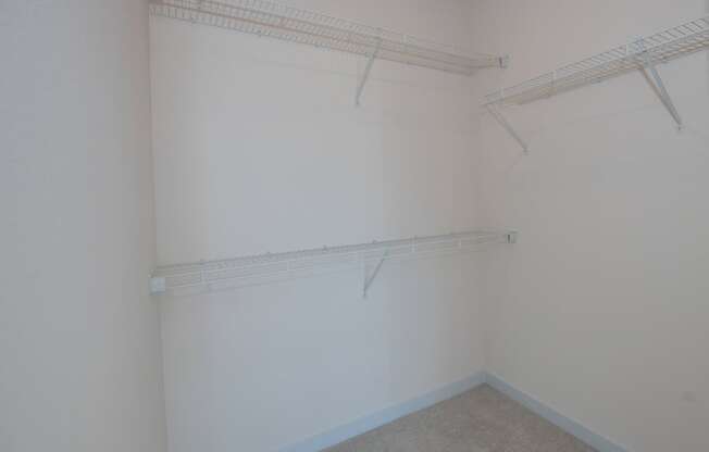 a room with a white wall and a hanging rack on the wall at The Crossings at Windsong, Arizona, 86314