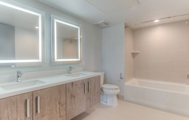 Bathroom With Double Sinks And Backlit Mirrors at The Mansfield at Miracle Mile, California