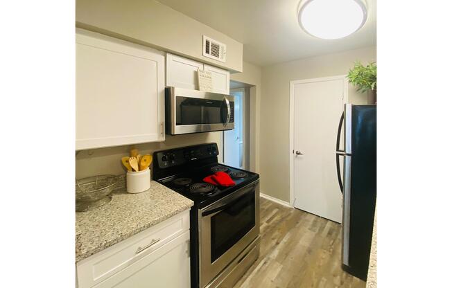 a kitchen with a stove and a refrigerator