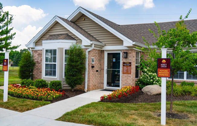 a brick house with a red sign in front of it