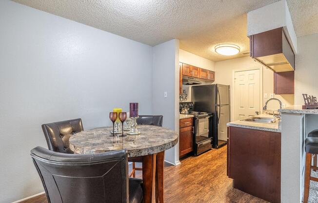 a kitchen and dining room with a table and chairs