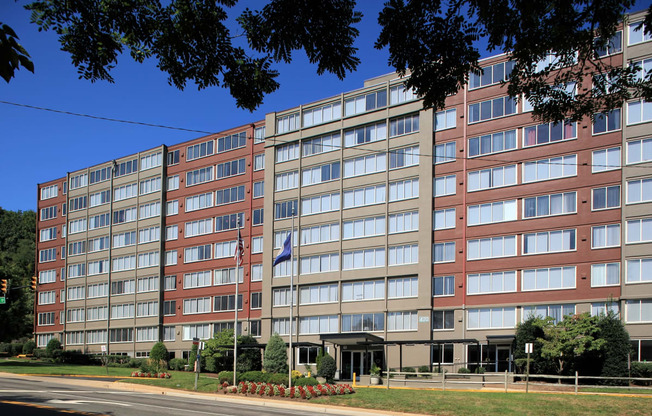 an apartment building on a city street with a flag