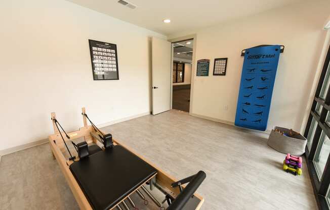 a room with a desk and a large blue climbing wall at Pinnacle Apartments, Florida, 32256