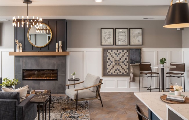 A modern living room with a fireplace and a chandelier.