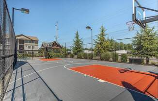 A basketball court with a basketball hoop and a backboard at Forestplace Apartment Homes, Oregon