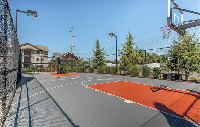 A basketball court with a basketball hoop and a backboard at Forestplace Apartment Homes, Oregon