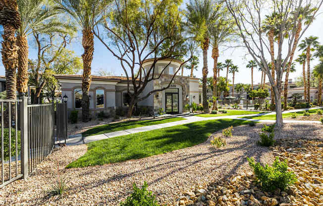A house with a white fence and a green lawn.