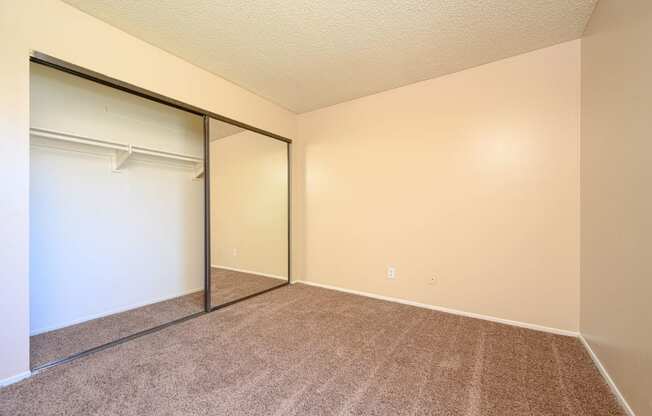 a bedroom with a closet and a window at Oak Terrace Senior Apts, Hemet, 92543