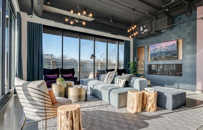 a living room with a large window and a couch and tables