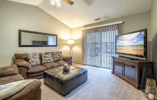 Living room with large sliding doors at Fountain Glen Apartments