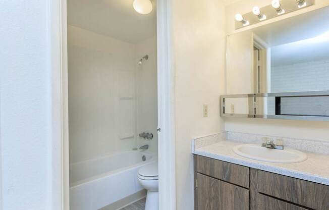 A white bathroom with a white tub and sink.