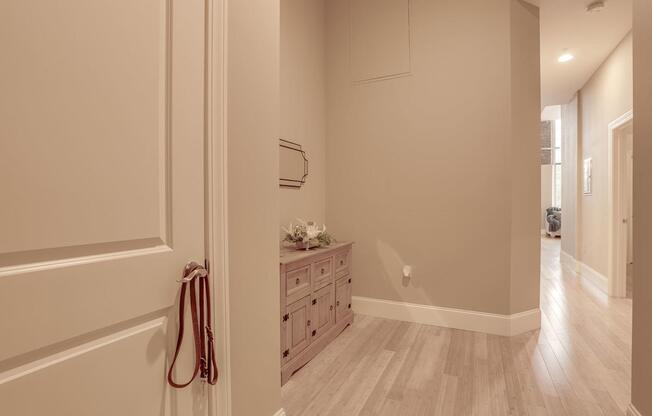 a hallway with a dresser and a mirror in a house