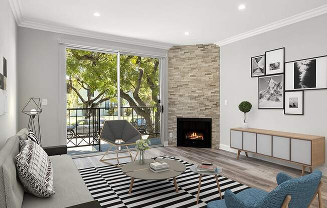 Hardwood floored living room with balcony access and stone walled fireplace.