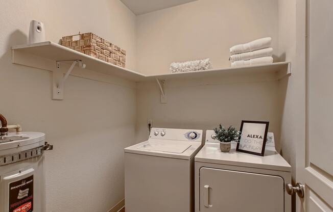 Fairview, OR Apartments for Rent - Laundry Room with Shelving and In-Unit Washer and Dryer.