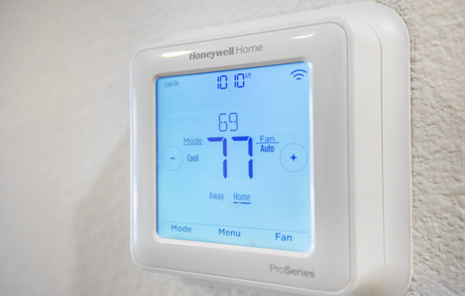 A Honeywell Home Pro Series thermostat shows the temperature is 77 degrees.