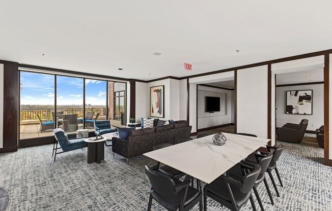 a large living room with a table and chairs and a balcony