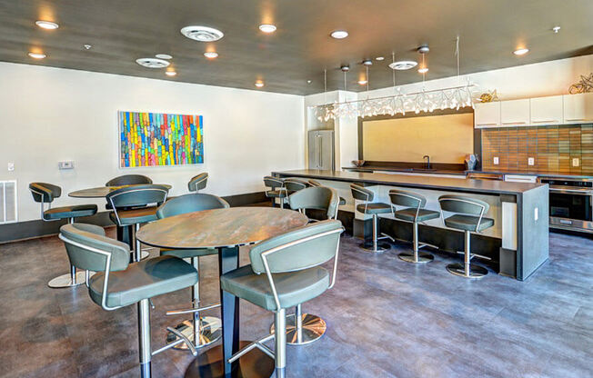 a room with a long table and chairs and a kitchen in the background  at Fusion, Jacksonville, FL, 32256