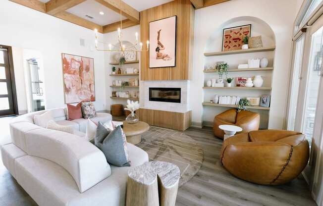 A living room with a white couch and a brown leather chair.
