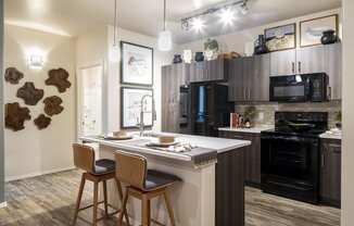 a kitchen with a large center island with two stools