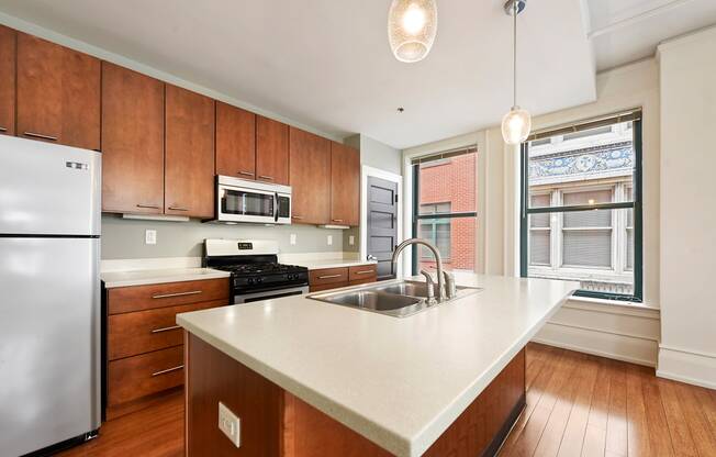 a kitchen with wooden cabinets and a white counter top