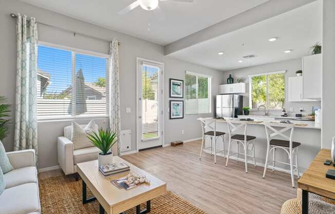 an open living room and kitchen with a dining table and chairs