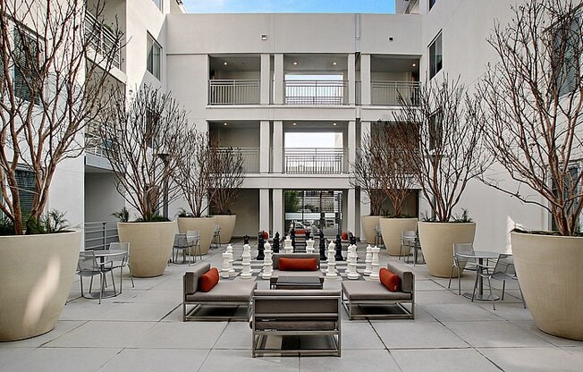 a courtyard with a large chess board in the middle of it