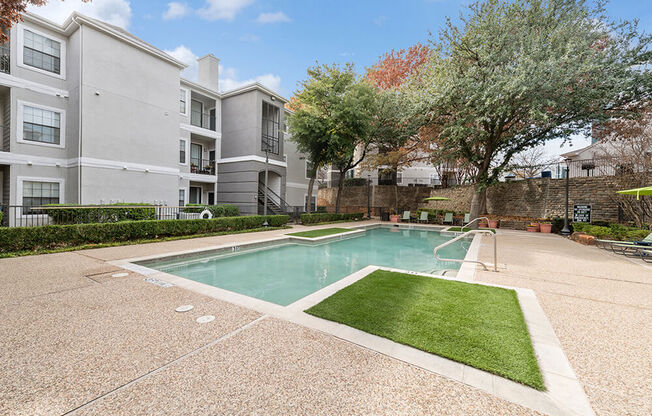 Community Swimming Pool with Pool Furniture at Bridges at Oakbend Apartments in Lewisville, TX.