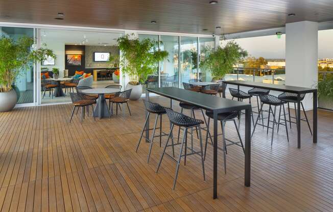 a cafeteria with tables and chairs on a wooden floor