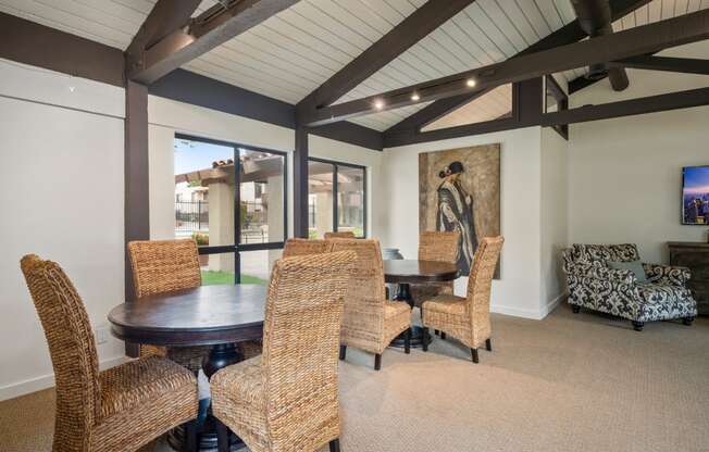 a dining room with a wooden table and chairs