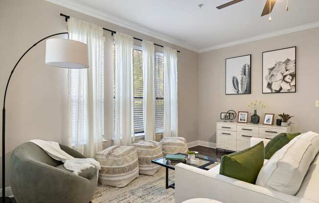 a living room with white curtains and a couch and a table at The Verandah, Texas, 78726