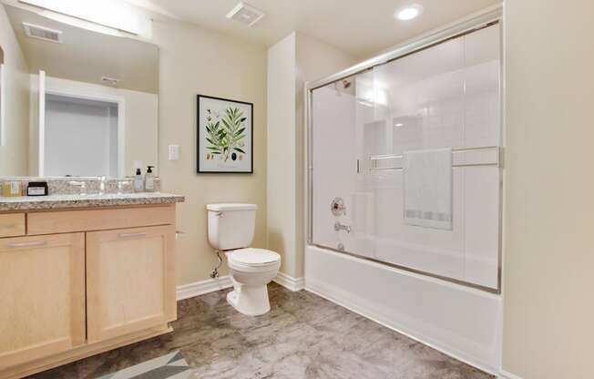 a bathroom with a shower toilet and sink