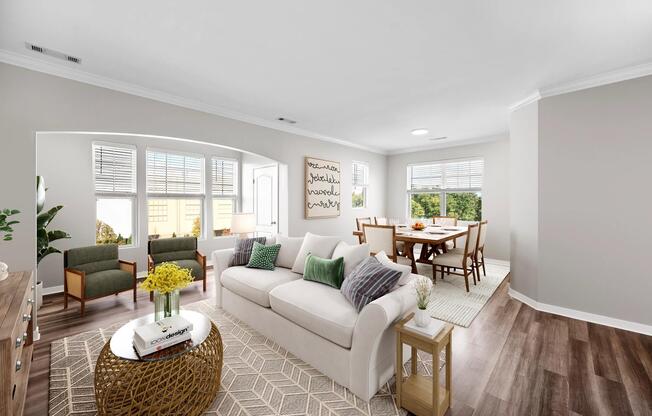 Sunlit living and dining area with expansive windows, warm flooring, and an open layout that brings comfort and connection to everyday living.