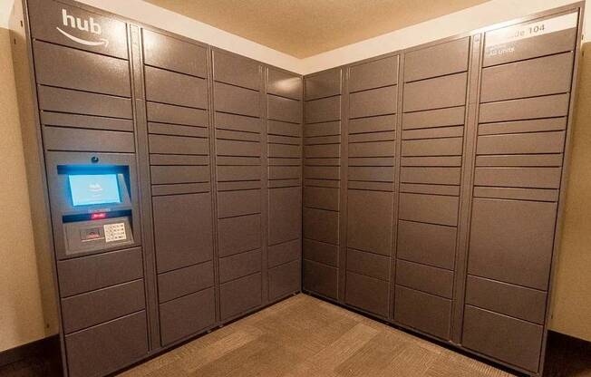 A row of lockers with a computer screen on the left at Ellyson Apartment Homes, Tacoma, Washington