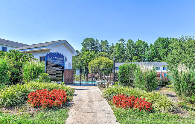 a sidewalk leading to a gate and the pool deck