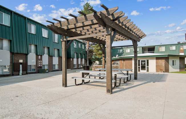 a pavilion with benches in front of a building