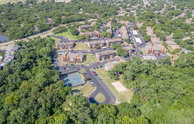 An aerial view of a school surrounded by trees.