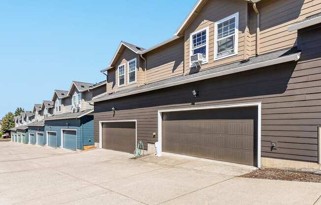 A row of townhomes with garages in front at The Landing Apartments and Townhomes, Oregon, 97045