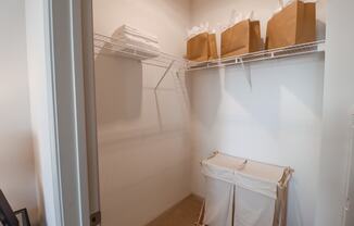 a walk in closet in a small room with boxes on the shelf and a white at The Crest at Acworth, Acworth, GA, 30102