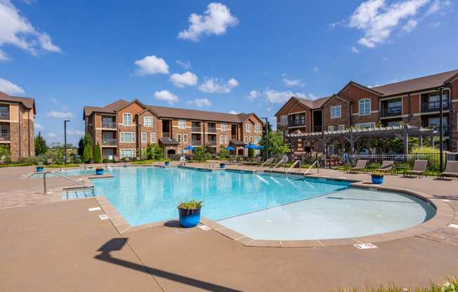 a swimming pool with an apartment building in the background