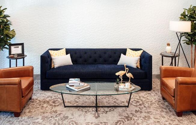 a living room with a blue couch and a glass table at Barrington 101, Chicago