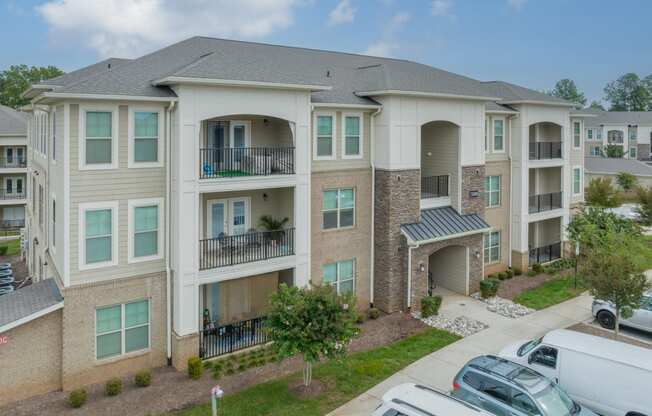 an apartment building with cars parked in front of it