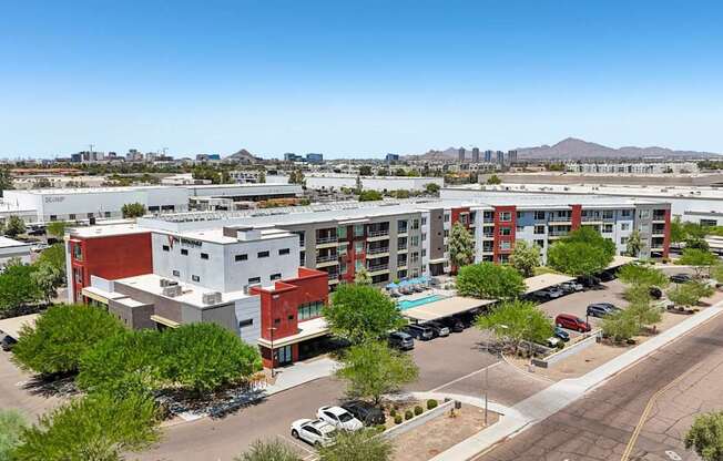 A large multi-story building with a parking lot in front.