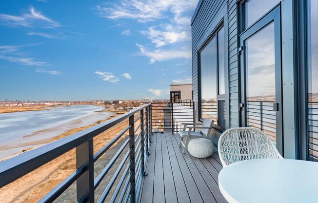 Enjoy your private balcony with sweeping water views and space to relax above the shoreline.