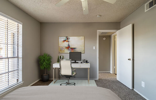 large bedroom with room for a desk and natural light