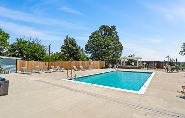 the swimming pool at our apartments has a pool and lounge chairs